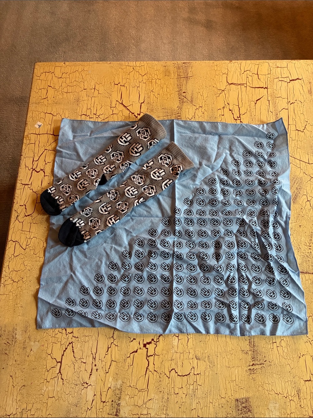 Blue Bandana with Hand Eye Emblem Print and Gray Black Patterned Socks